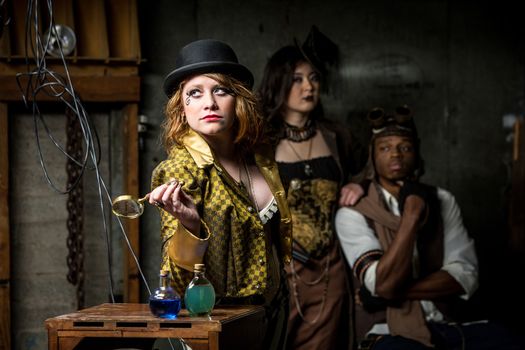 Three Steampunks with in Retro Lab with Potions