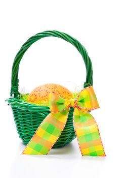 Easter egg in a basket on white background