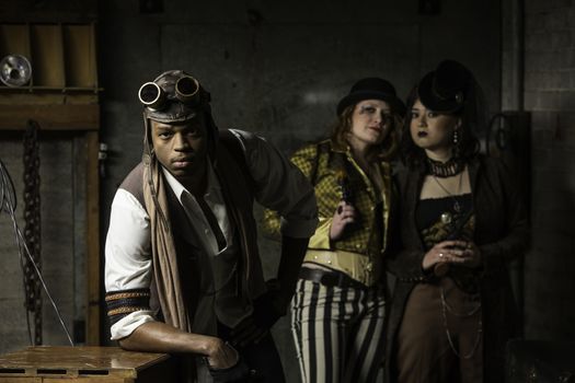 Young Steam Punks PosIng in Underground Lair