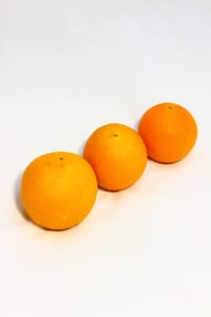 on a white background Three bright juicy orange from big to small