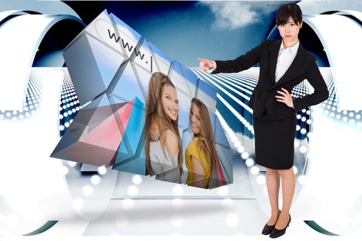 Focused businesswoman pointing against abstract design in blue and white