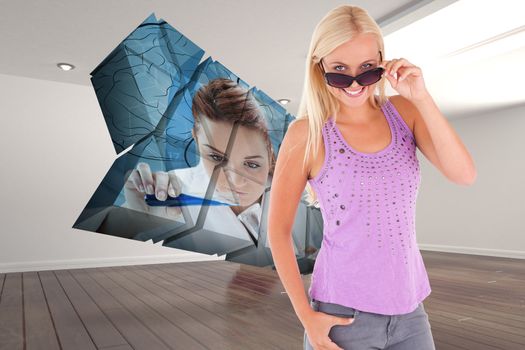 Charming woman peeking over her sunglasses against digitally generated room with stairs