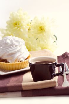 Coffee and cake with whipped cream near chrysanthemums