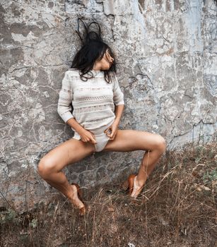 Portrait of a girl against old concrete wall
