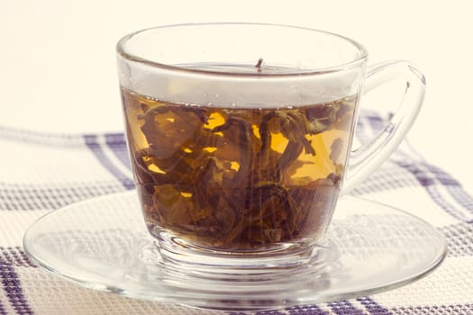 Green leaf tea in a transparent cup