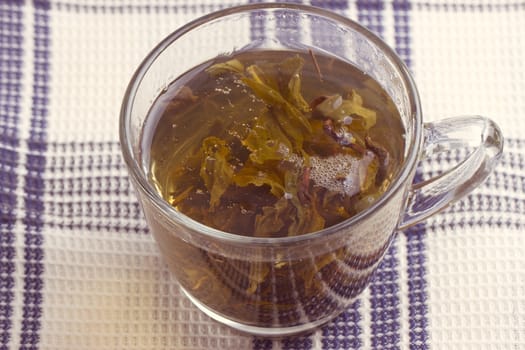 Green leaf tea in a transparent cup