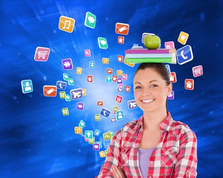 Pretty student holding an apple and books on her head against abstract blue squares