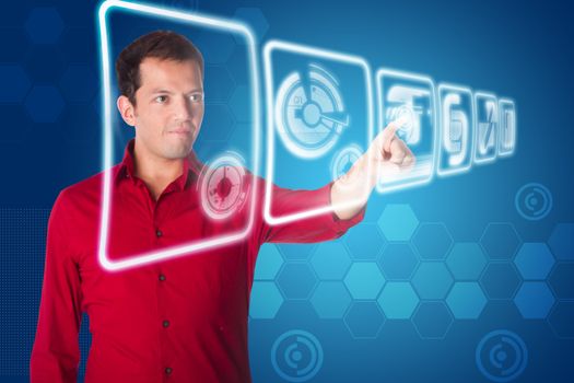 Business man in red shirt clicking on futuristic interface of hologram touch screens with graphs and charts on blue.