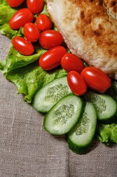 Traditionally pita with lettuce and fresh tomatoes with cucumbers shot closeup