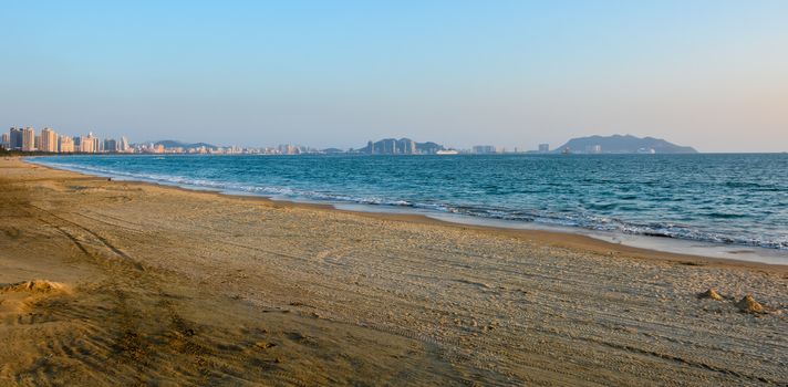 The Sanya bay beach under the sunset.