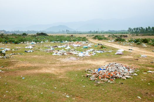 Spontaneous garbage dump in asian countryside
