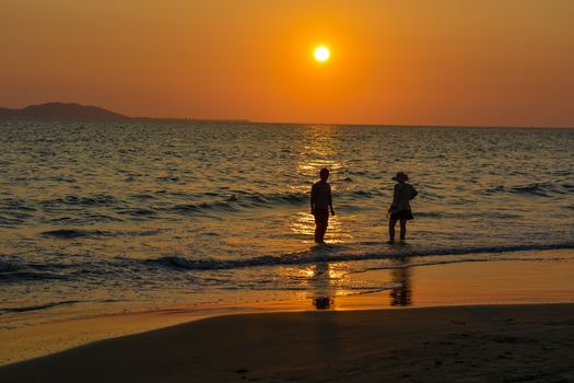 The Sanya bay beach under the sunset.