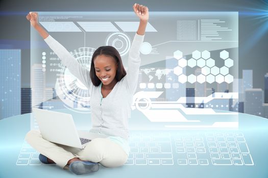 Young woman stretching while on the floor with her laptop against futuristic technology interface