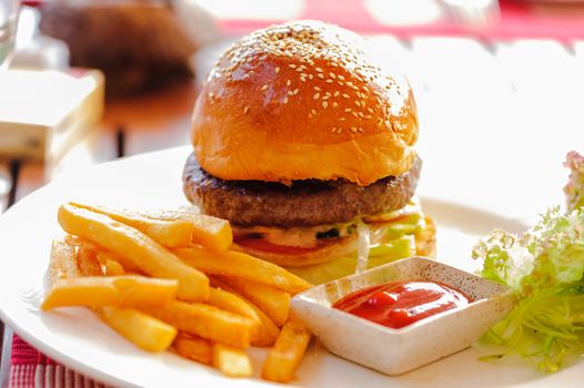 a beef cheeseburger in restaurant on table.