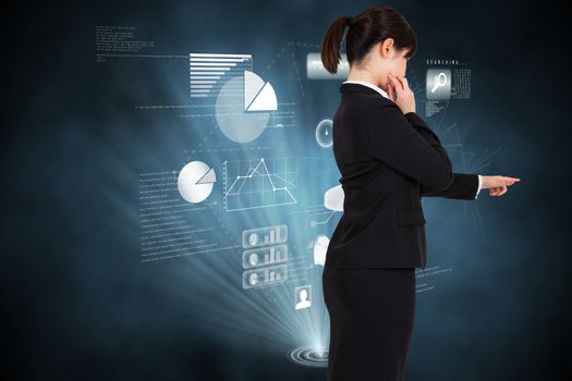 Businesswoman pointing against futuristic technology interface