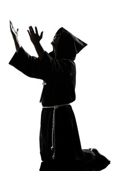 one caucasian man priest praying silhouette in studio isolated on white background