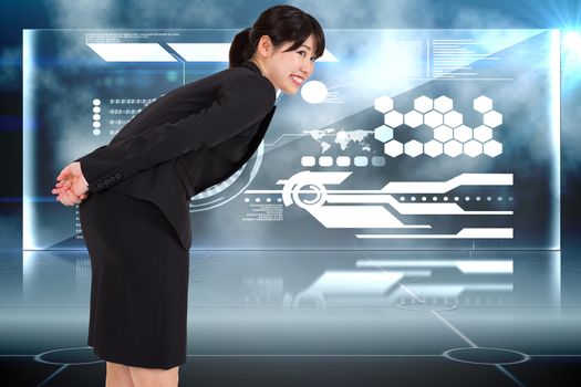 Smiling businesswoman bending against futuristic technology interface