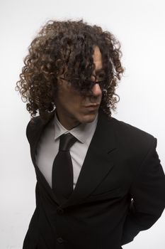 Cropped portrait of mediterranean looking man with curly hair wearing business suit and sun glasses