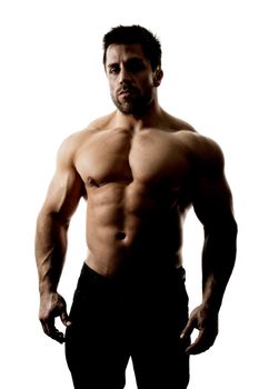 A handsome muscular sports man hard lit with deep shadows isolated on a white background