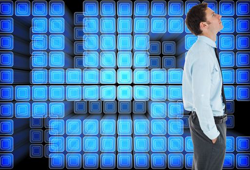 Serious businessman standing with hand in pocket against abstract technology background