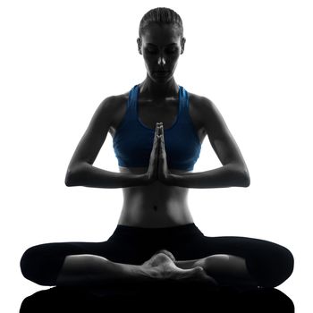 one caucasian woman exercising yoga meditating sitting hands joined in silhouette studio isolated on white background