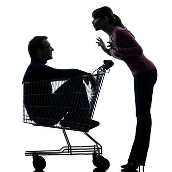 one caucasian couple woman with man sitting in shopping cart  in silhouette studio isolated on white background