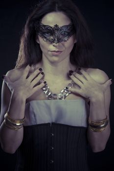 Sexy.Beautiful young woman in mysterious black Venetian mask. Fashion photo. tribal design.