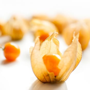 ripe healthy orange physalis over wooden board