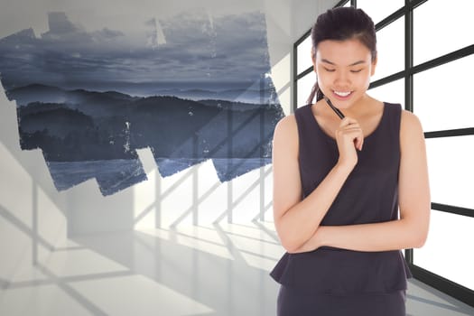 Thinking businesswoman against abstract screen in room showing mountains