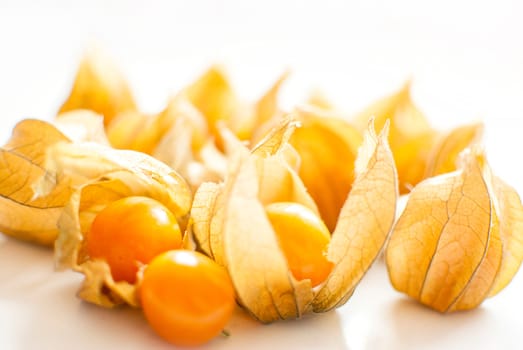 ripe healthy orange physalis over wooden board