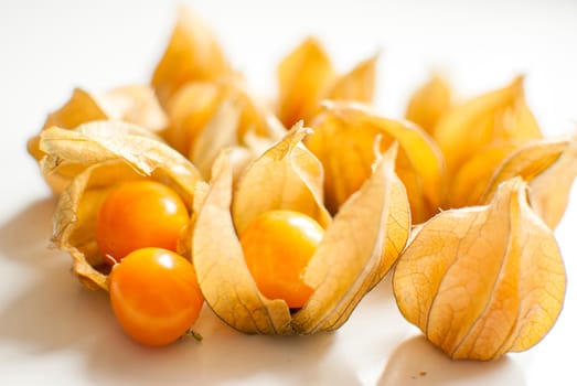 ripe healthy orange physalis over wooden board