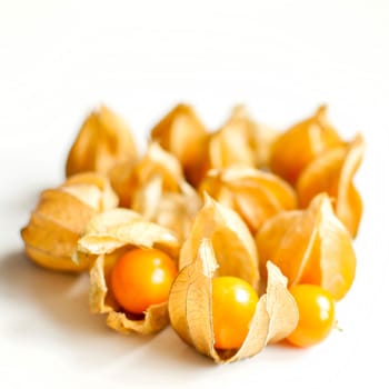 ripe healthy orange physalis over wooden board