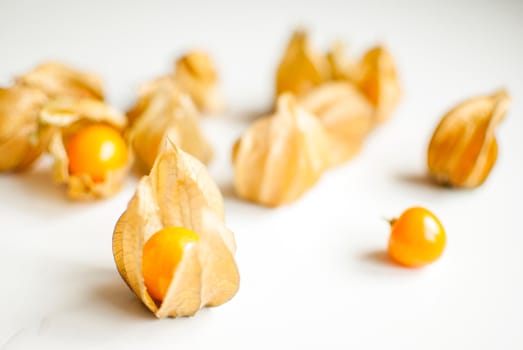 ripe healthy orange physalis over wooden board