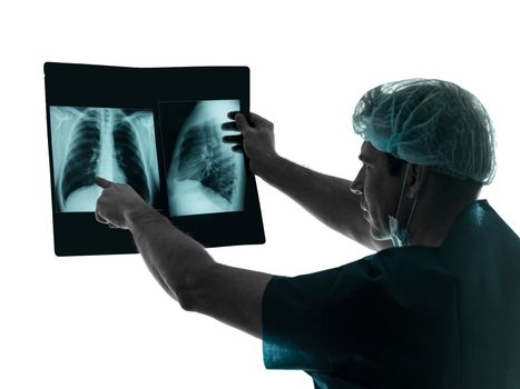 one caucasian man doctor surgeon radiologist medical examining lung torso x-ray image silhouette isolated on white background
