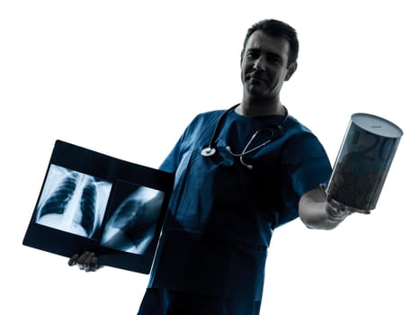 one caucasian man doctor surgeon radiologist medical worker holding a money box silhouette isolated on white background