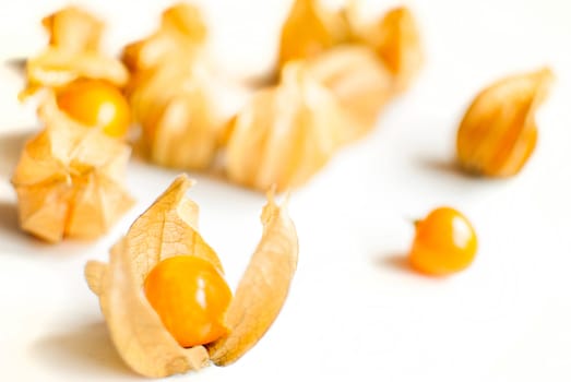 ripe healthy orange physalis over wooden board