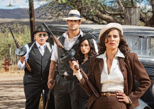 Four diverse 1920s vintage gangsters outside