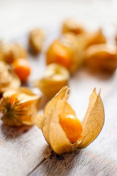 ripe healthy orange physalis over wooden board