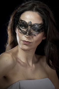 Vintage.Beautiful young woman in mysterious black Venetian mask. Fashion photo. tribal design.