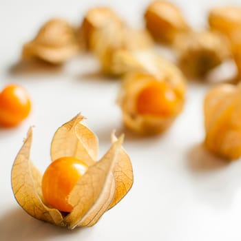 ripe healthy orange physalis over wooden board