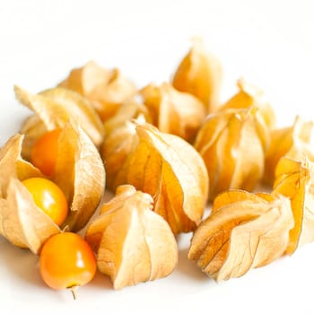 ripe healthy orange physalis over wooden board