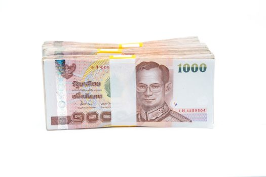 Stacks of 1000 baht bills isolated on white background