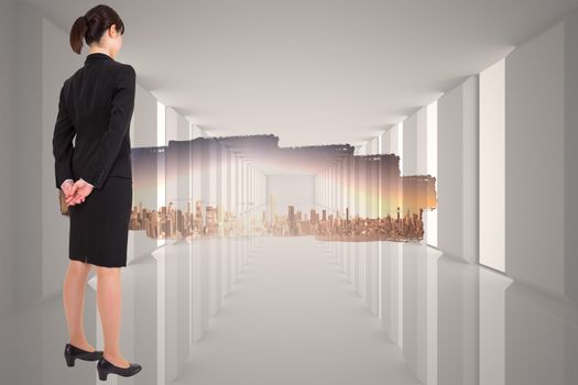 Businesswoman standing against abstract screen in room showing cityscape