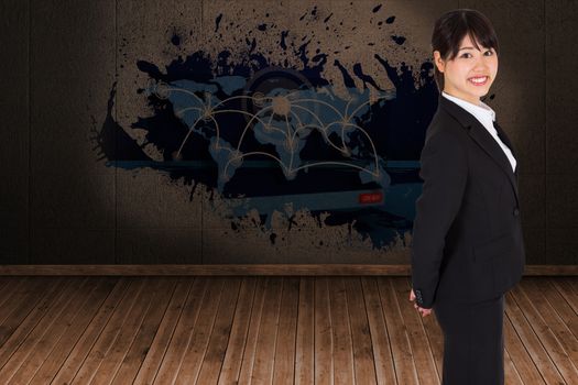 Smiling businesswoman against splash on wall revealing technology interface
