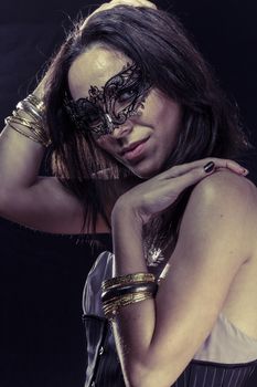 Sensuality.Beautiful young woman in mysterious black Venetian mask. Fashion photo. tribal design.