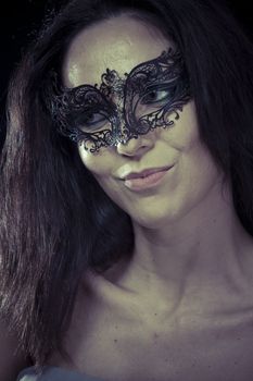 Sexy.Beautiful young woman in mysterious black Venetian mask. Fashion photo. tribal design.