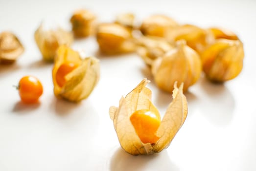 ripe healthy orange physalis over wooden board