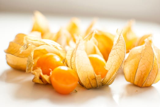 ripe healthy orange physalis over wooden board