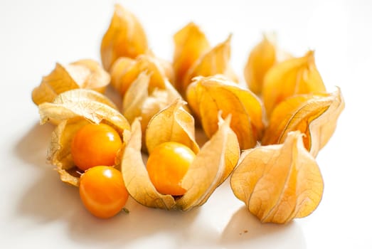 ripe healthy orange physalis over wooden board