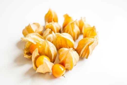 ripe healthy orange physalis over wooden board